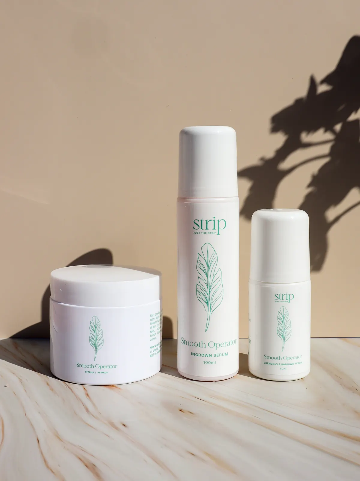 Smooth Operator Ingrown Hair Serum by Just The Strip in a jar, a spray bottle and a roll-on