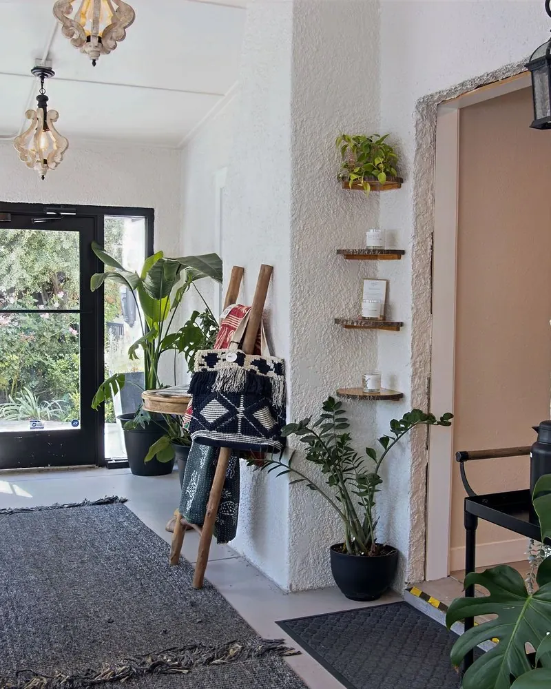 The bright entry at Wax &amp; Lash Berkeley with plants and a jewelry wall