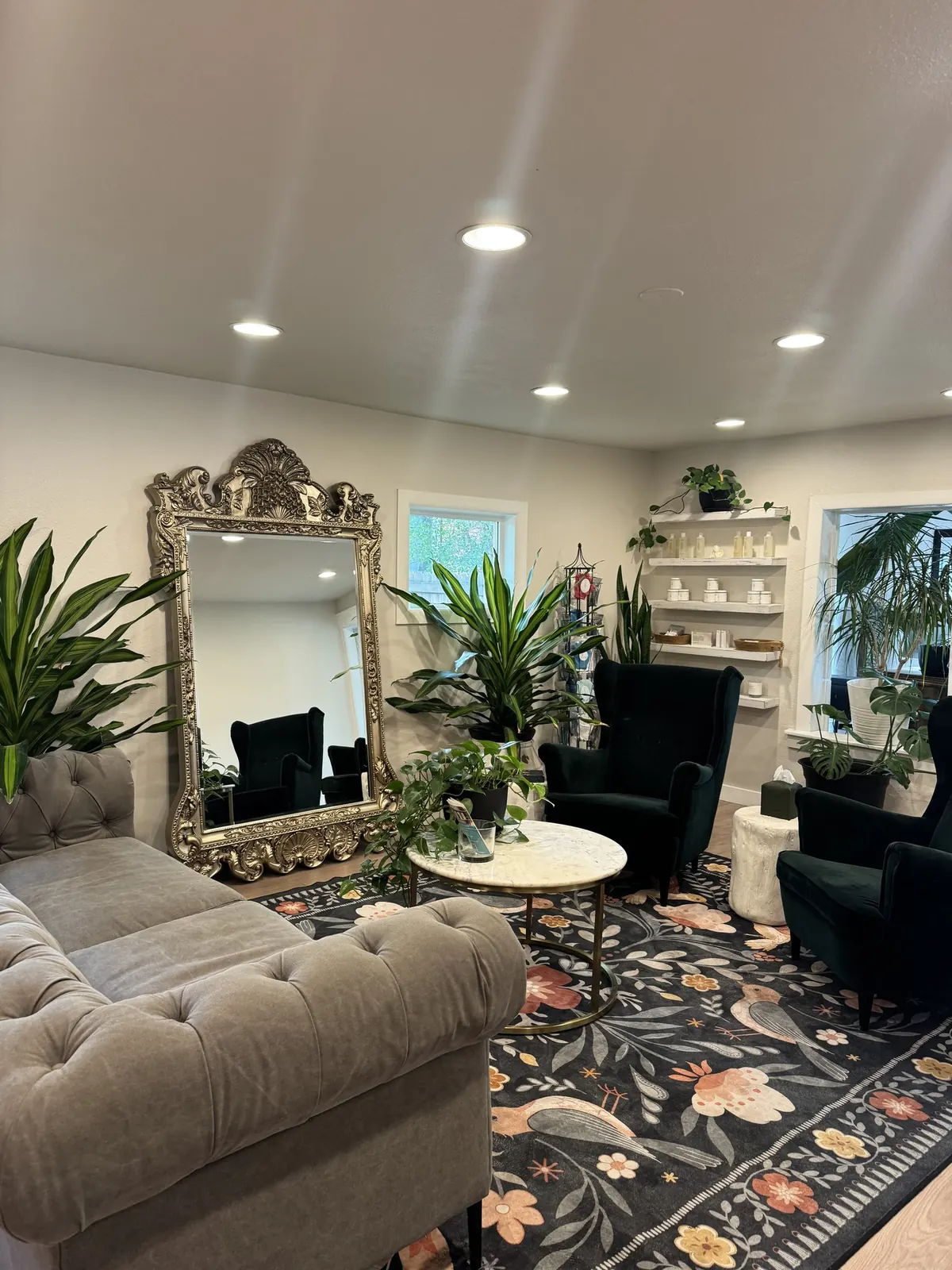 Wax & Lash Berkeley lounge The lounge at Wax & Lash Berkeley with a gilded mirror, velvet chairs and green plants