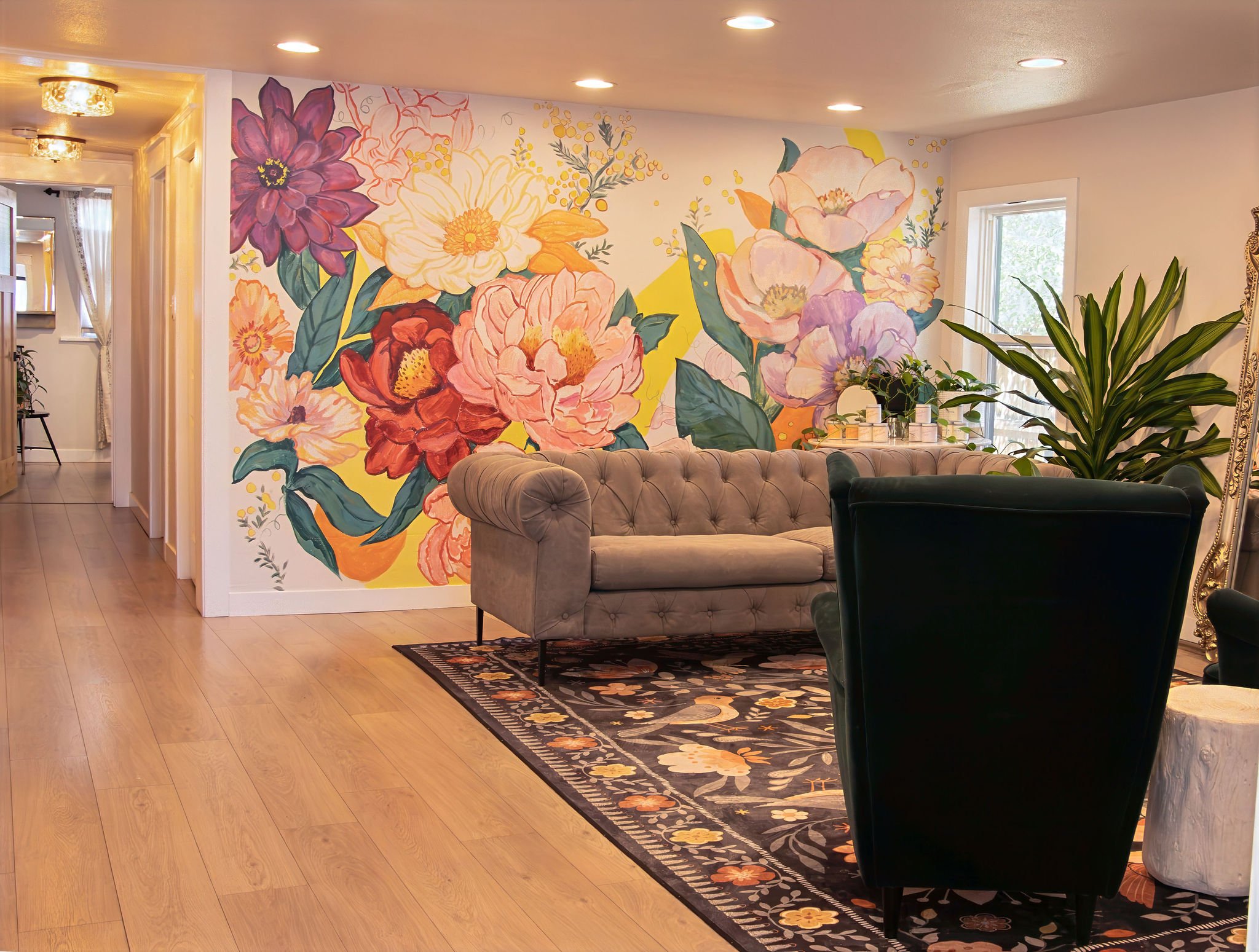 The client lounge at Wax & Lash Berkeley in Denver with its hand painted floral mural