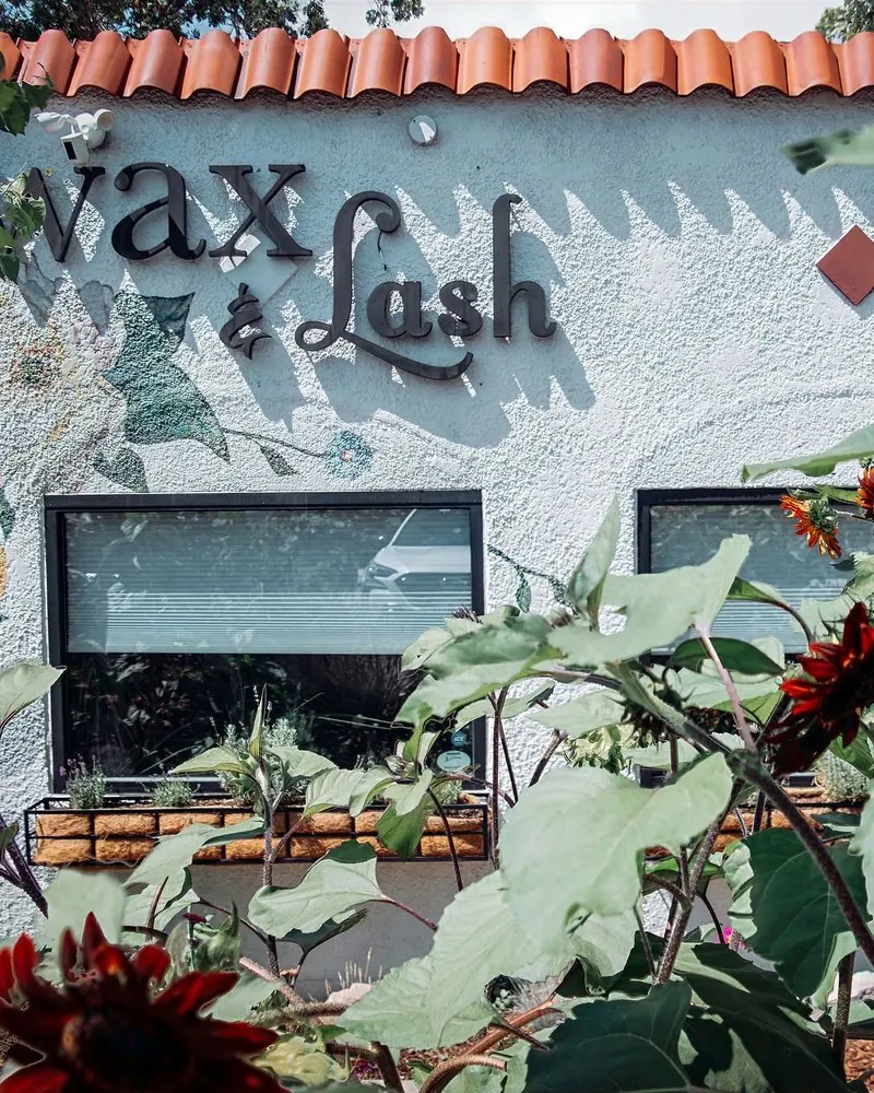 Sunflowers in front of the Wax &amp; Lash Berkeley sign