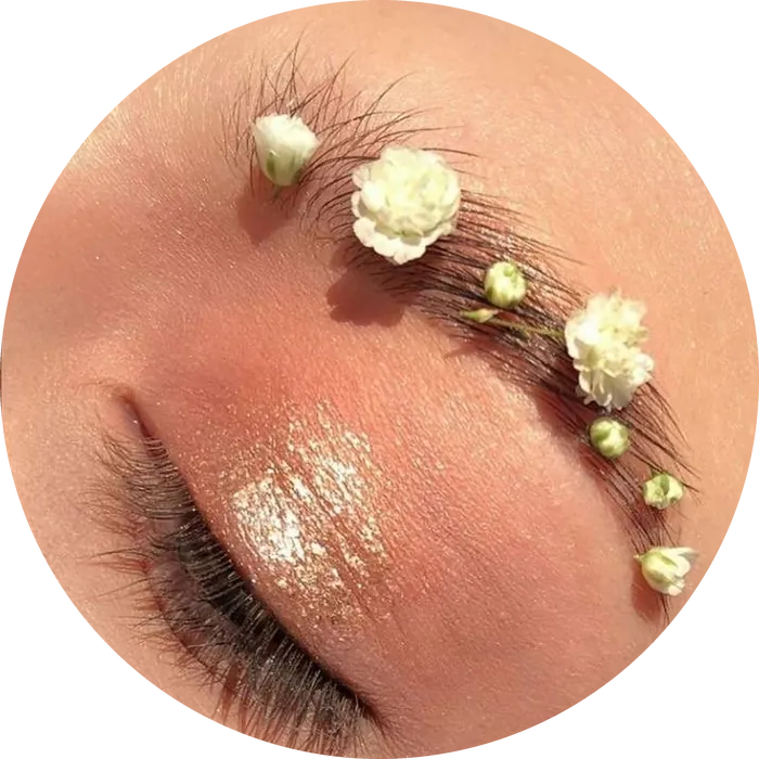 A shaped brow decorated with small white flowers